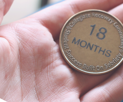 A coin with a text that says 18 months.